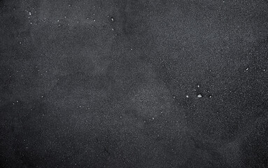 Fototapeta premium Dark or black concrete surface with distinct textures and patterns enhances visual appeal. Background