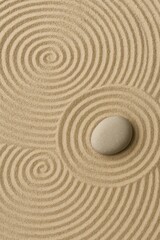 Zen sand garden with smooth stone, concentric raked lines; calming minimal backdrop for spa, wellness, meditation.
