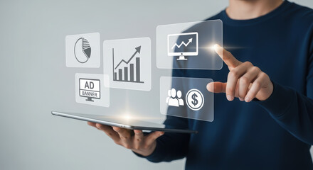Male professional interacting with digital interface on tablet, showcasing graphs, charts, and icons, representing data analysis and marketing strategies in a modern workspace