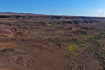 The Red Mountains of Boguta. Mountainous clay terrain. The view from the drone. Summer evening time. National Nature Park.