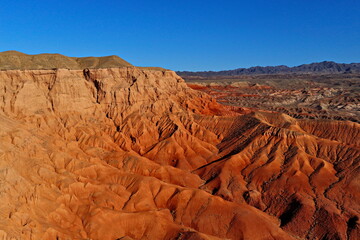 The Red Mountains of Boguta. Mountainous clay terrain. The view from the drone. Summer evening time. National Nature Park.