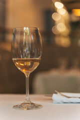 Glass of White Wine on Restaurant Table. Elegant Dining Atmosphere