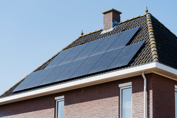 Fototapeta premium Solar Panels on House Roof: Sustainable energy source for home. Reduce carbon footprint with solar power.