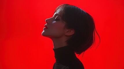 Minimalist Portrait of a Woman Against a Vibrant Red Background in Realistic Photography Style