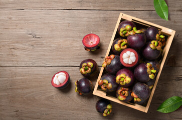 Frsh mangosteen fruit in wooden crate.