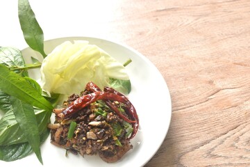 spicy fried chop pork salad Thai northern style with fresh vegetable on plate