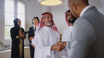 Business professional presenting monthly sales data on whiteboard, communicating strategic insights to arab investors during collaborative meeting in modern corporate environment - Powered by Adobe