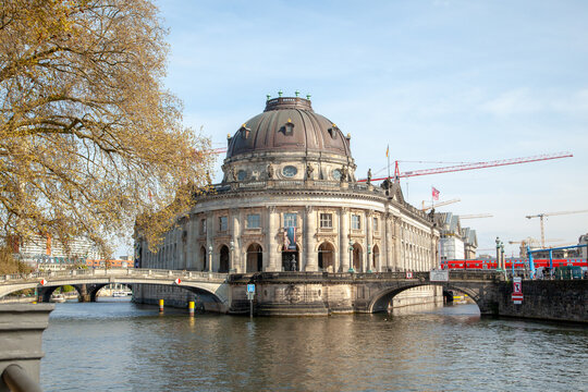 Museum island in autumn, Berlin, Germany with flag Holbein exhibition