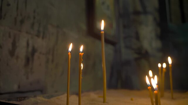 burning candles in an orthodox church and cross