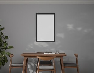A minimalist dining room features a grey wall, a dark wood dining table with four chairs, a potted plant, and a blank rectangular framed poster on the wall.  Sunlight casts shadows