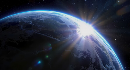 Sunrise view of Earth from space, with bright light radiating across the planet.