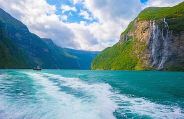 Obraz premium Waterfall falling from a mountain in a fjord in Jotunheimen National Park in Norway, August 6, 2025