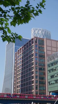 A Railway moving through Canary Wharf. Vertical, London, England