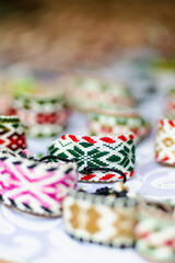 Fototapeta premium Details of a traditional Lithuanian weave. Woven belts as a part of national Lithuanian costume sold on traditional Easter fair in Vilnius, Lithuania