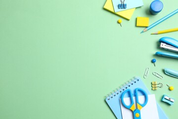 Flat lay with colorful school stationery on green background, top view © Sunlight