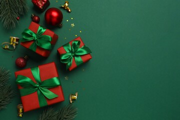 Decorative Christmas gifts and ornaments are neatly arranged below against green background