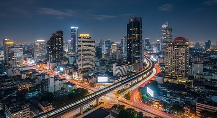 Fototapeta premium Cityscape at Night with Illuminated Skyscrapers and Transportation Network