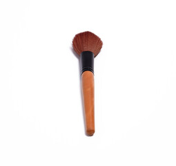 Makeup brush with dense brown bristles and a wooden handle, ideal for applying powder or blush