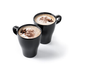 Chai Latte in Black Mug with cinnamon and star anise isolated on white background. Copy space