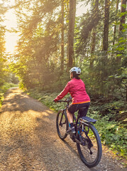 Obraz premium nice senior woman cycling and having fun in the Allgaeu Alps near Oberstaufen, Bavaria, Germany