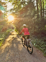 Naklejka premium nice senior woman cycling and having fun in the Allgaeu Alps near Oberstaufen, Bavaria, Germany
