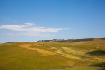Alpine pasture and blue sky scenery on Karajun Grassland, Xinjiang, China