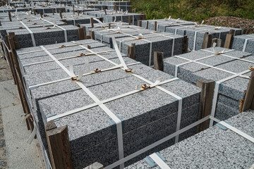 Paving slabs in pallets at the construction site on the sidewalk.