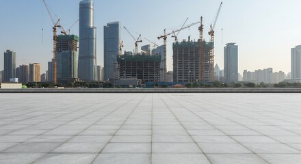 Modern Cityscape Construction Site with Tower Cranes, Skyscrapers, and a Tiled Foreground Under a Clear Sky, Emphasizing Urban Development and Architectural Design