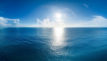 Obraz premium blue ocean panorama with sun reflection ripple waves and calm sea with beautiful sunlight