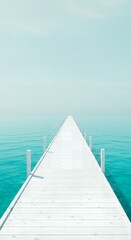 Obraz premium Wooden pier stretching out into calm turquoise ocean under clear sky