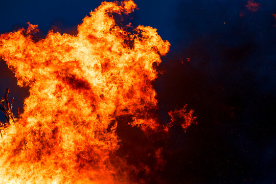 Large bonfire at summer solstice celebration outdoors