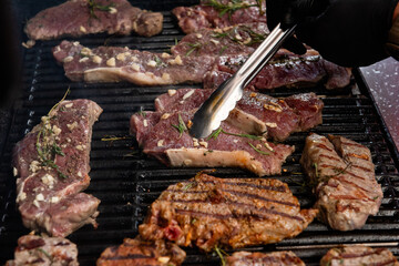 delicious steaks are being cooked on the grill