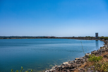 Barragem de Morgavel reservoir with clear blue water in Alentejo Portugal