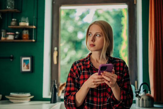 Woman using smartphone for secure login at home