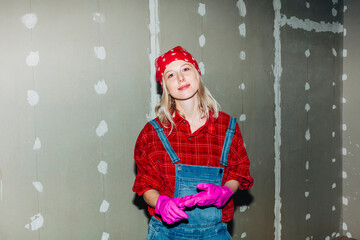 Confident DIY worker plastering drywall in modern home interior