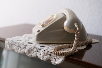 Old white rotary phone with Disc Dial with finger, putting retro phone reciver down, telephone conversation, Vintage communication device