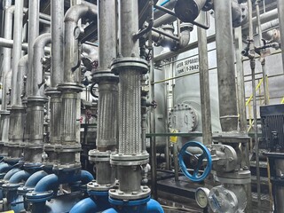 a complex industrial pumping system with multiple electric motors and pumps arranged in a row. A...