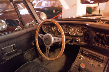 Fototapeta premium vintage classic car interior with steering wheel, Oldtimer car retro-style heritage, manual gear shift, timeless automotive passion, history automotive industry, vintage car restoration