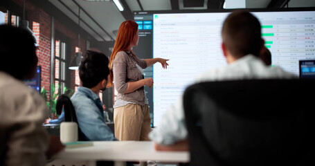 Multiracial Executive Training Team Using Spreadsheet Data