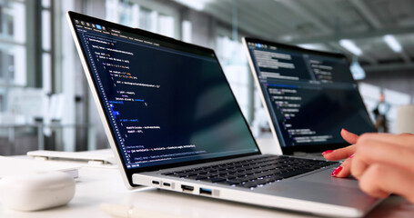 Young Woman Coding Software In Office