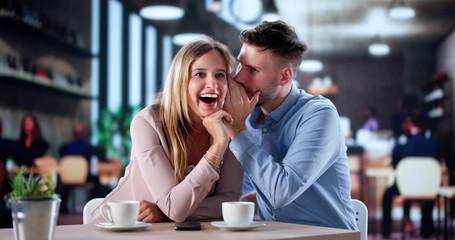 Whispering Couple Shares Secrets In Cozy Cafe