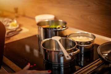 Hands, cooking and pot with steam in the home for lunch or dinner, busy and hungry for food with preparation. Catering, meal with nutrition in kitchen.