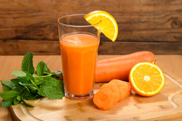 Refreshing orange and carrot juice with garnish