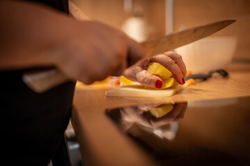 Close up photo of female hands is preparing wonderful fresh potato food. Chef cooking food cutting prepare hands knife preparing potato.