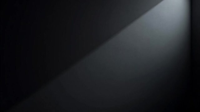 A beam of light cuts through the darkness creating a stark contrast in a dimly lit environment