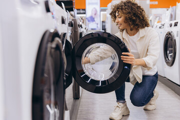 Woman Choosing Washing Machine in Appliance Store