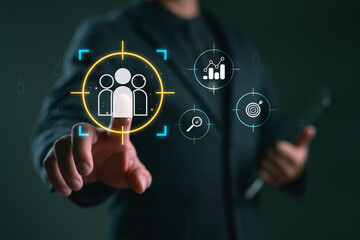 Businessman touching target audience icon with digital marketing and analytics symbols. Concept of customer targeting, market segmentation, CRM and data-driven strategy.
