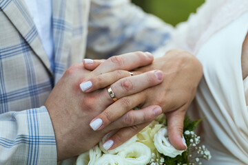 Hands of newlyweds with wedding rings, close-up.