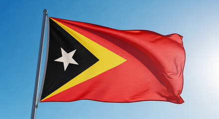 East Timor flag waving proudly against a bright blue sky, symbolizing patriotism and freedom