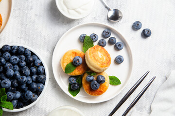 syrniki . Appetizing cheesecakes with sauce and blueberries